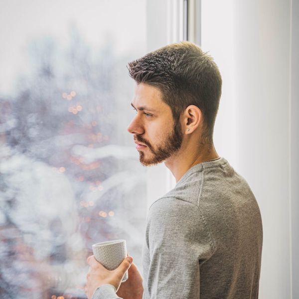 Person looking thoughtfully towards a bright window, symbolizing mental clarity.